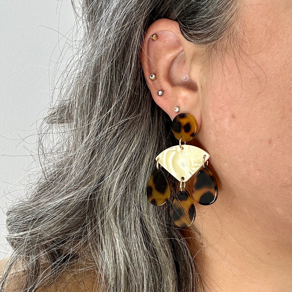 woman wearing acrylic Chandelier Drop Earrings in cream and tortoise