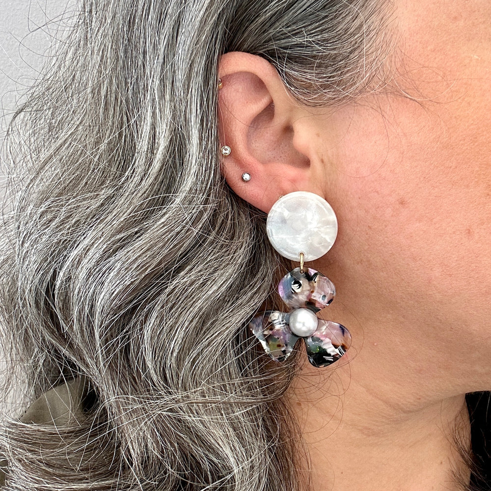 woman wearing acrylic Flower Drop Earrings in multicolor and white