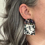 woman wearing acrylic Fringe Earrings in black, white and multicolor