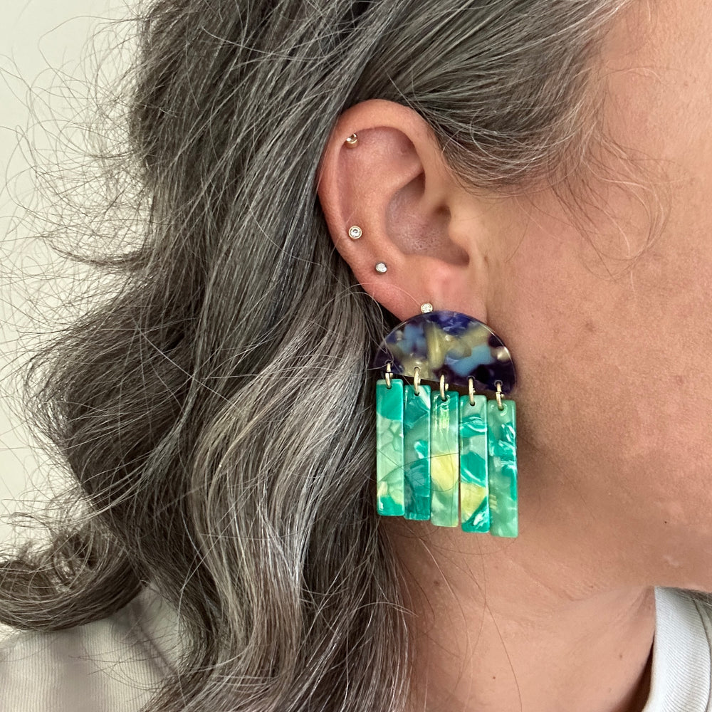 woman wearing acrylic Fringe Earrings in blue, lime green and yellow