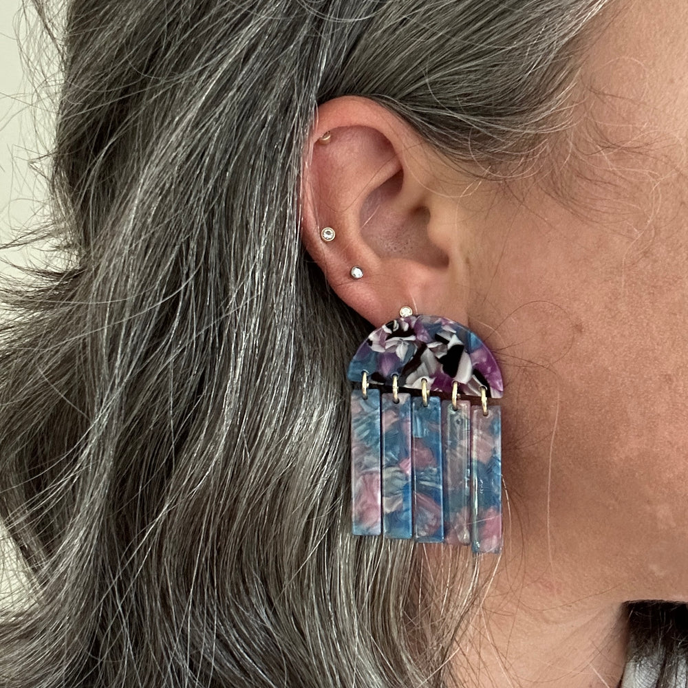 woman wearing acrylic Fringe Earrings in blue, purple, pink and black