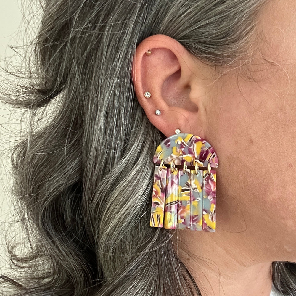 woman wearing acrylic Fringe Earrings in lilac, magenta and yellow