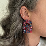 woman wearing acrylic Fringe Earrings in magenta pink and blue