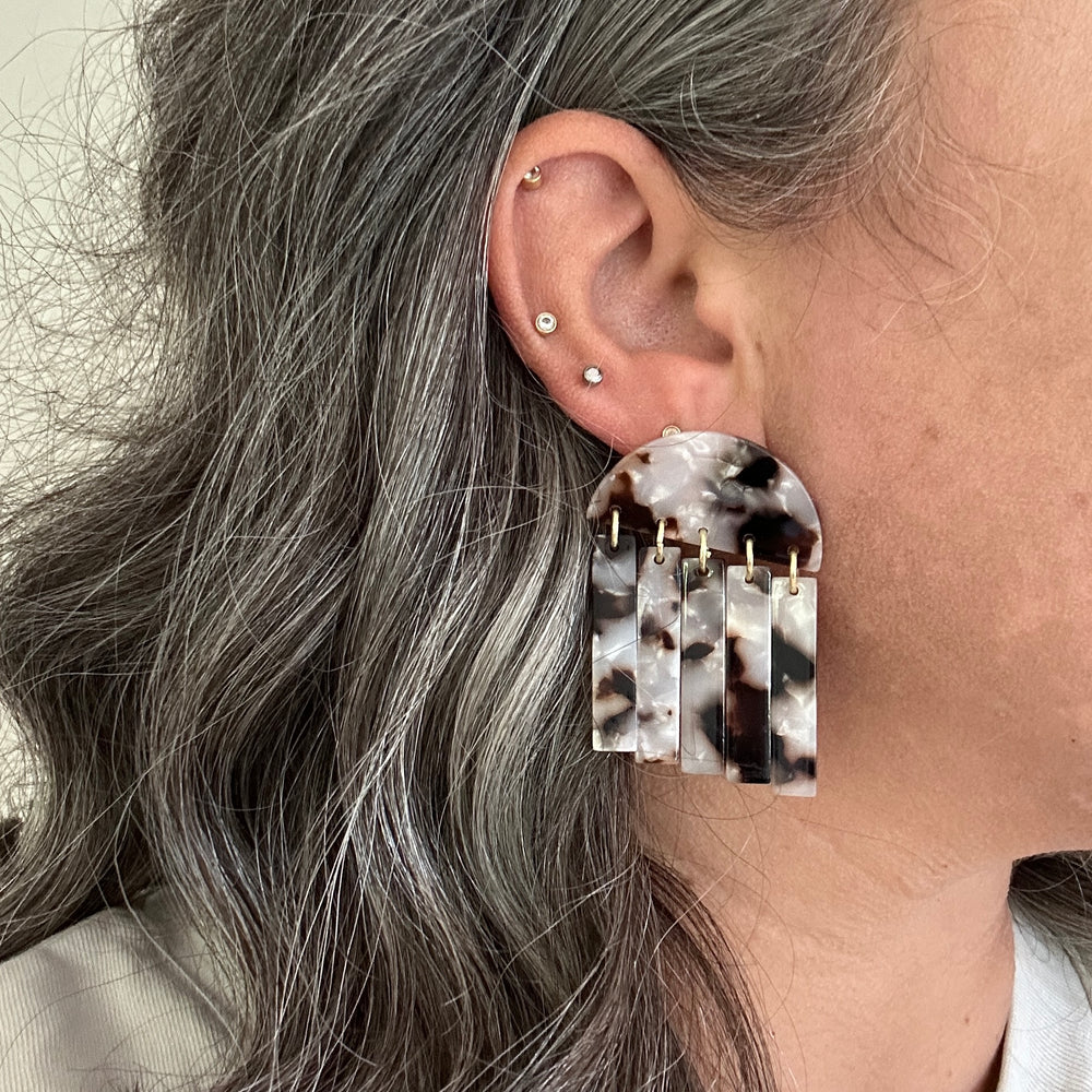 woman wearing acrylic Fringe Earrings in pearly tortoise, black, brown and white