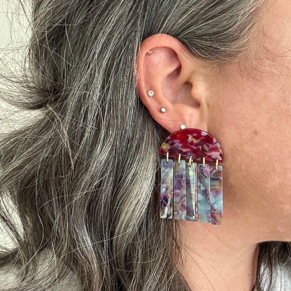 woman wearing acrylic Fringe Earrings in pink, blue, and purple