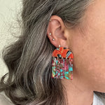 woman wearing acrylic Fringe Earrings in red, orange, yellow green and pink