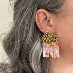 woman wearing acrylic Fringe Earrings in yellow, pink, and brown