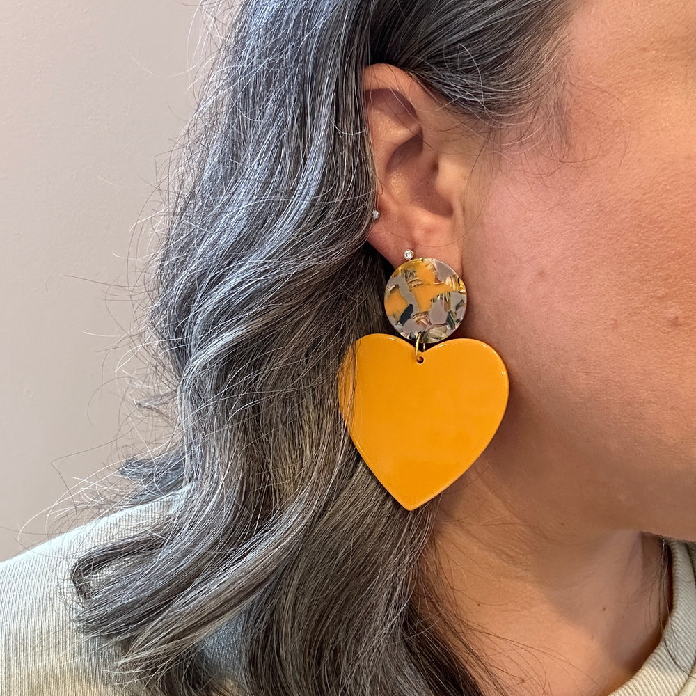 woman wearing  acrylic Heart Earrings in Pencil Me In, yellow, black, lilac, and green 