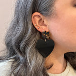 woman wearing acrylic Heart Earrings in Undercover Lover, black, yellow and brown