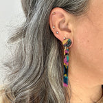 woman wearing acrylic Matchstick Drop Earrings in Jungle Punch yellow, green, black and deep purple