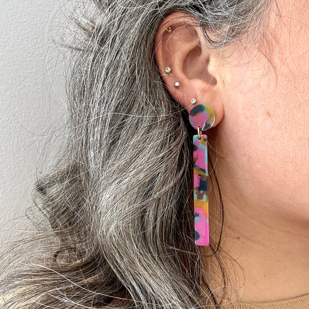 woman wearing acrylic Matchstick Drop Earrings in Tropical Punch yellow, blue and pink