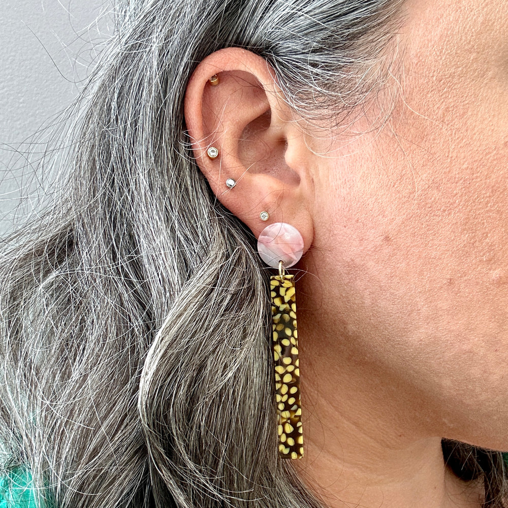 woman wearing acrylic Matchstick Drop Earrings in pink, brown, and yellow