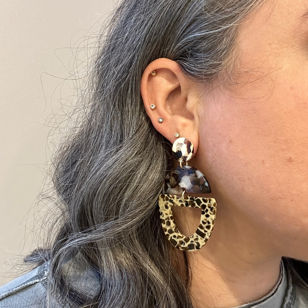 woman wearing acrylic Open Tab Drop Earrings in brown and beige