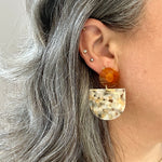 woman wearing acrylic Tab Drop Earrings in Peach, caramel and Cream