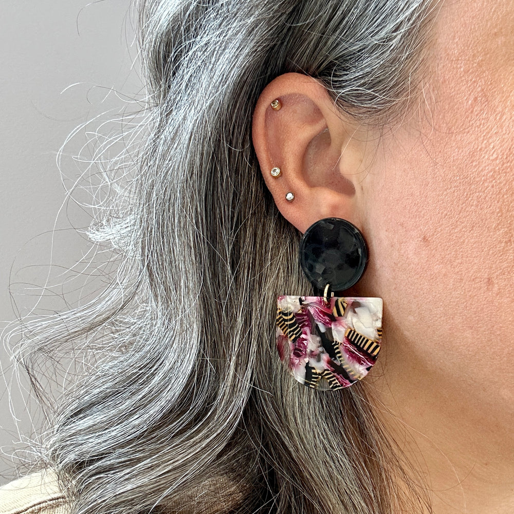 woman wearing acrylic Tab Drop Earrings in pink and black