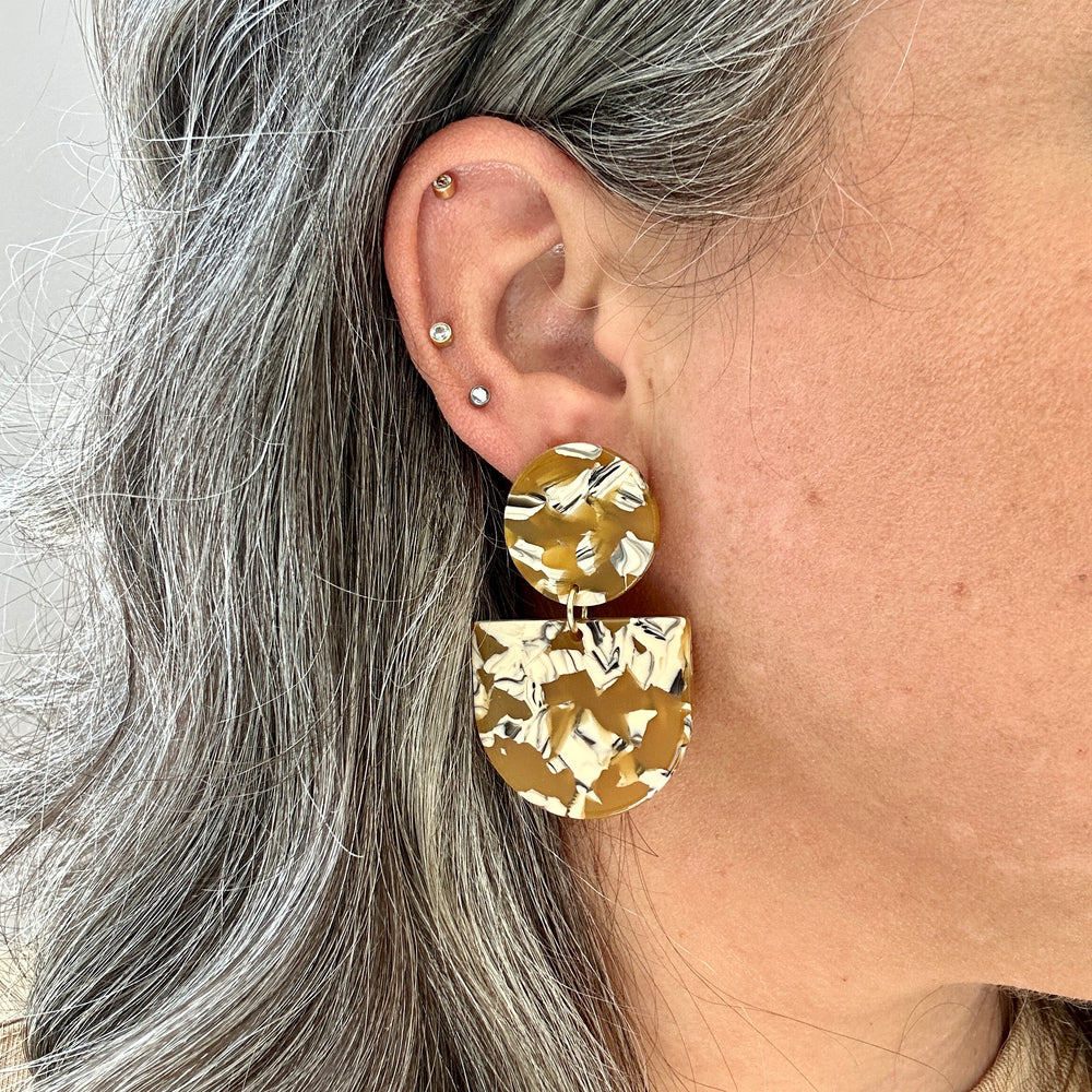 woman wearing acrylic Tab Drop Earrings in yellow, cream and black