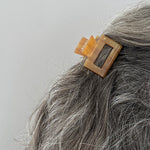 woman wearing acrylic claw clip in caramel brown