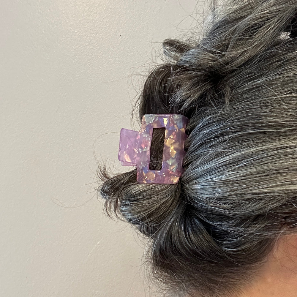 woman wearing acrylic claw clip in lilac purple