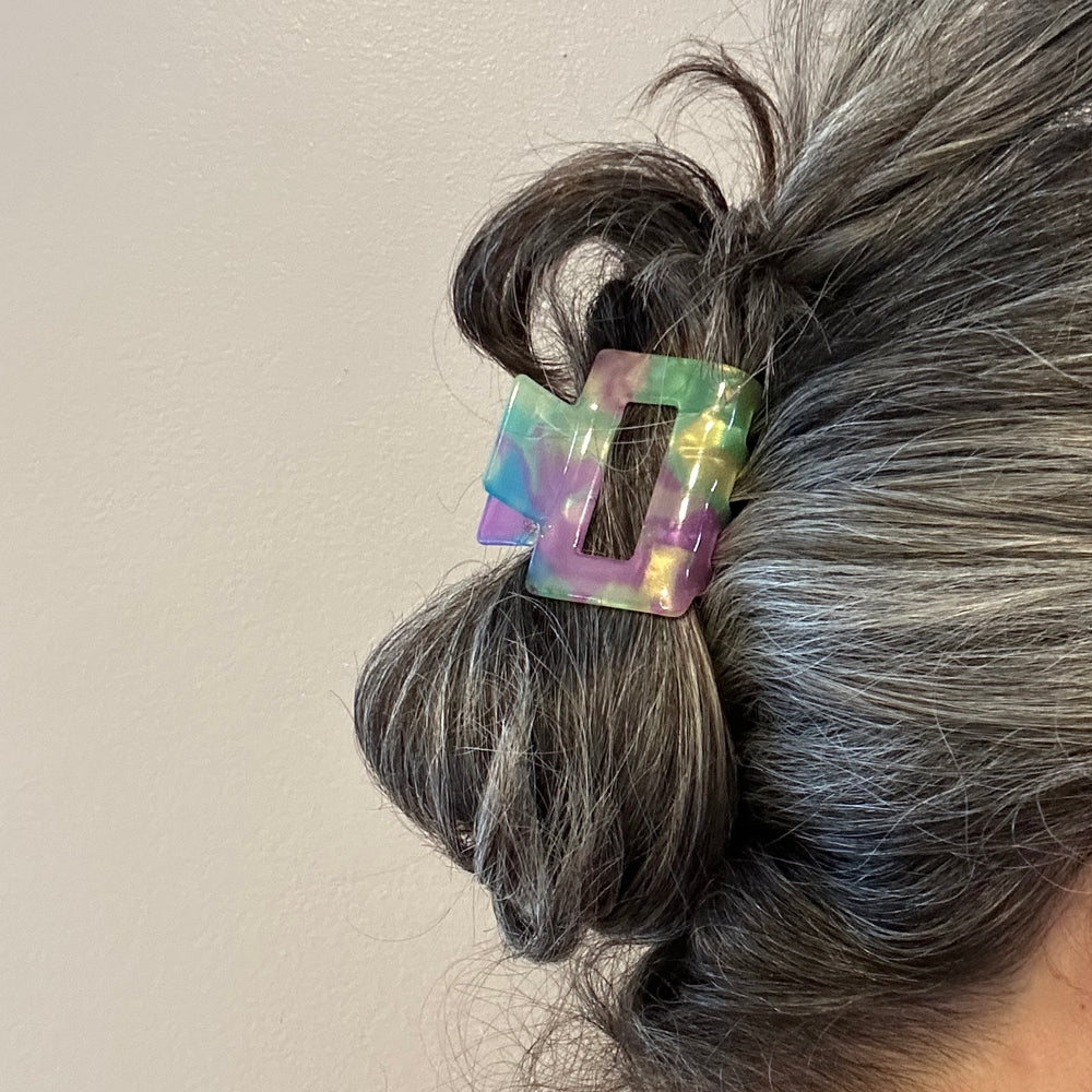 woman wearing acrylic claw clip in summer daze green purple blue and yellow