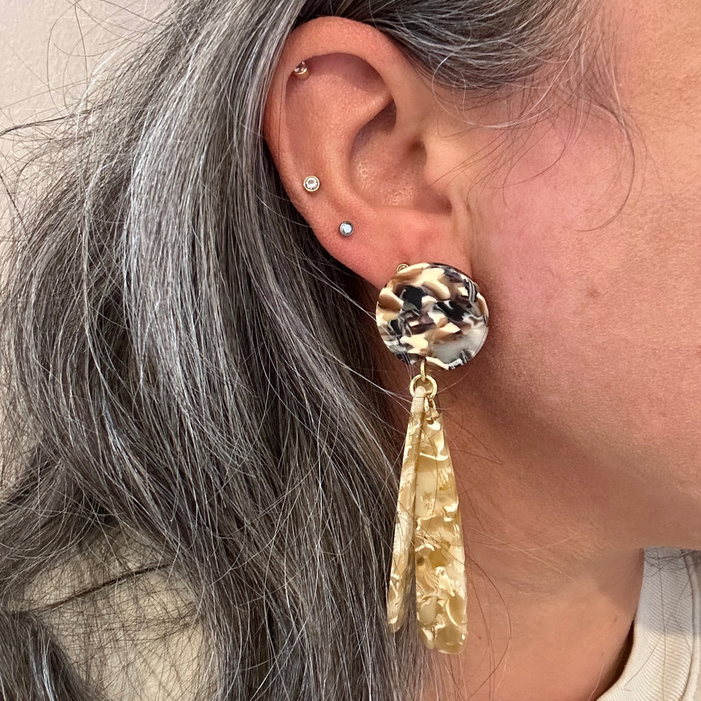 woman wearing acrylic flower Petal Drop Earrings in beige and brown