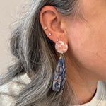 woman wearing acrylic flower Petal Drop Earrings in blue and pink