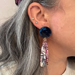 woman wearing acrylic flower Petal Drop Earrings in blue, pink and white