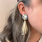 woman wearing acrylic flower Petal Drop Earrings in iridescent cream, blue, green and pink