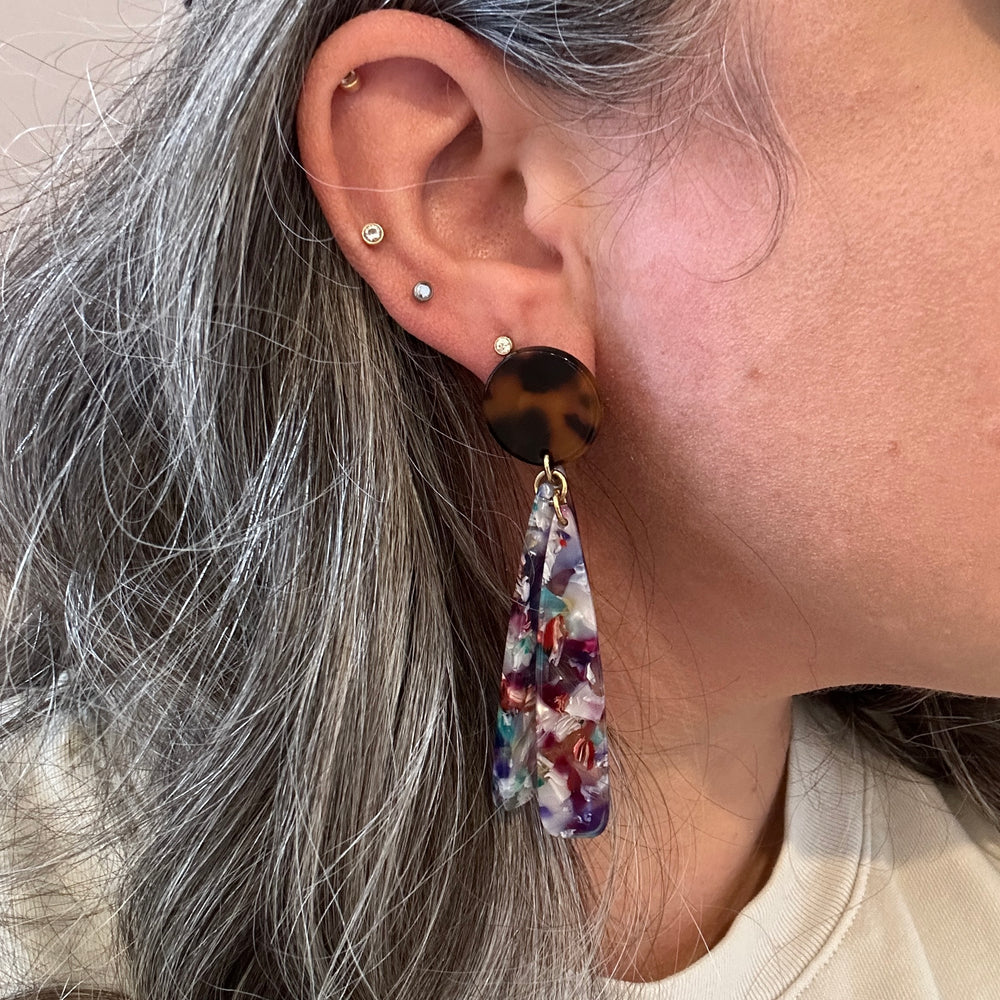 woman wearing acrylic flower Petal Drop Earrings in multicolor and tortoise