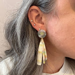 woman wearing acrylic flower Petal Drop Earrings in pastel green, pink and yellow