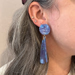 woman wearing acrylic flower Petal Drop Earrings in periwinkle, blue, purple