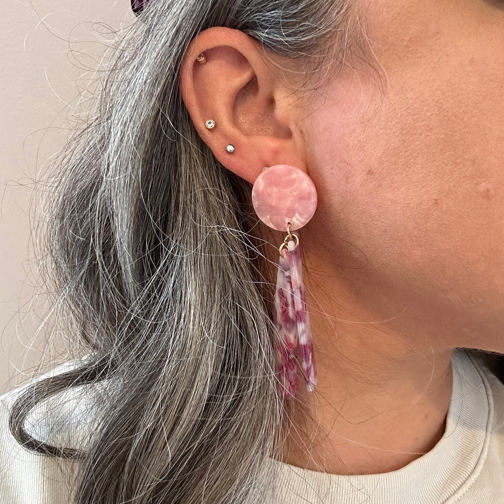 woman wearing acrylic flower Petal Drop Earrings in pink, purple and white