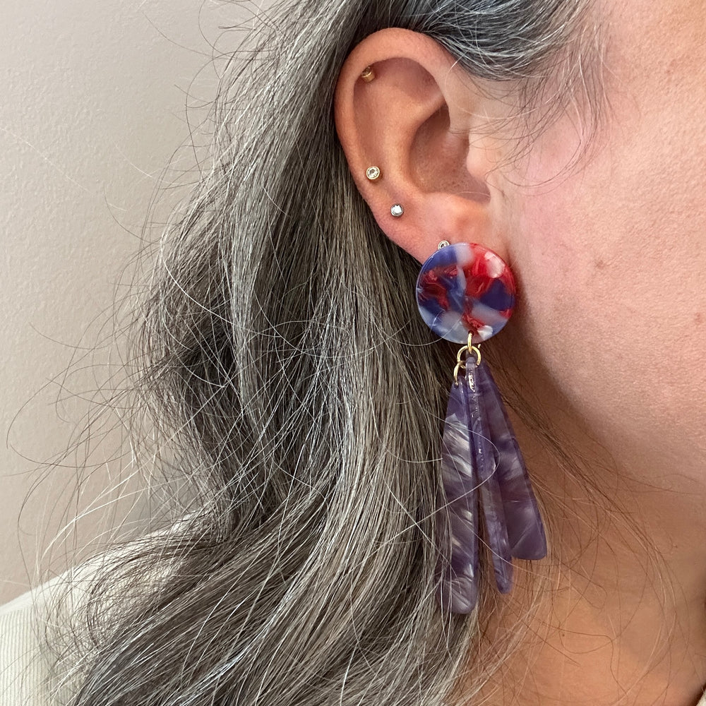 woman wearing acrylic flower Petal Drop Earrings in purple and red