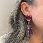 woman wearing acrylic flower Petal Drop Earrings in purple and red