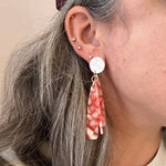 woman wearing acrylic flower Petal Drop Earrings in red and white