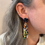 woman wearing acrylic flower Petal Drop Earrings in red, white, yellow, blue and green