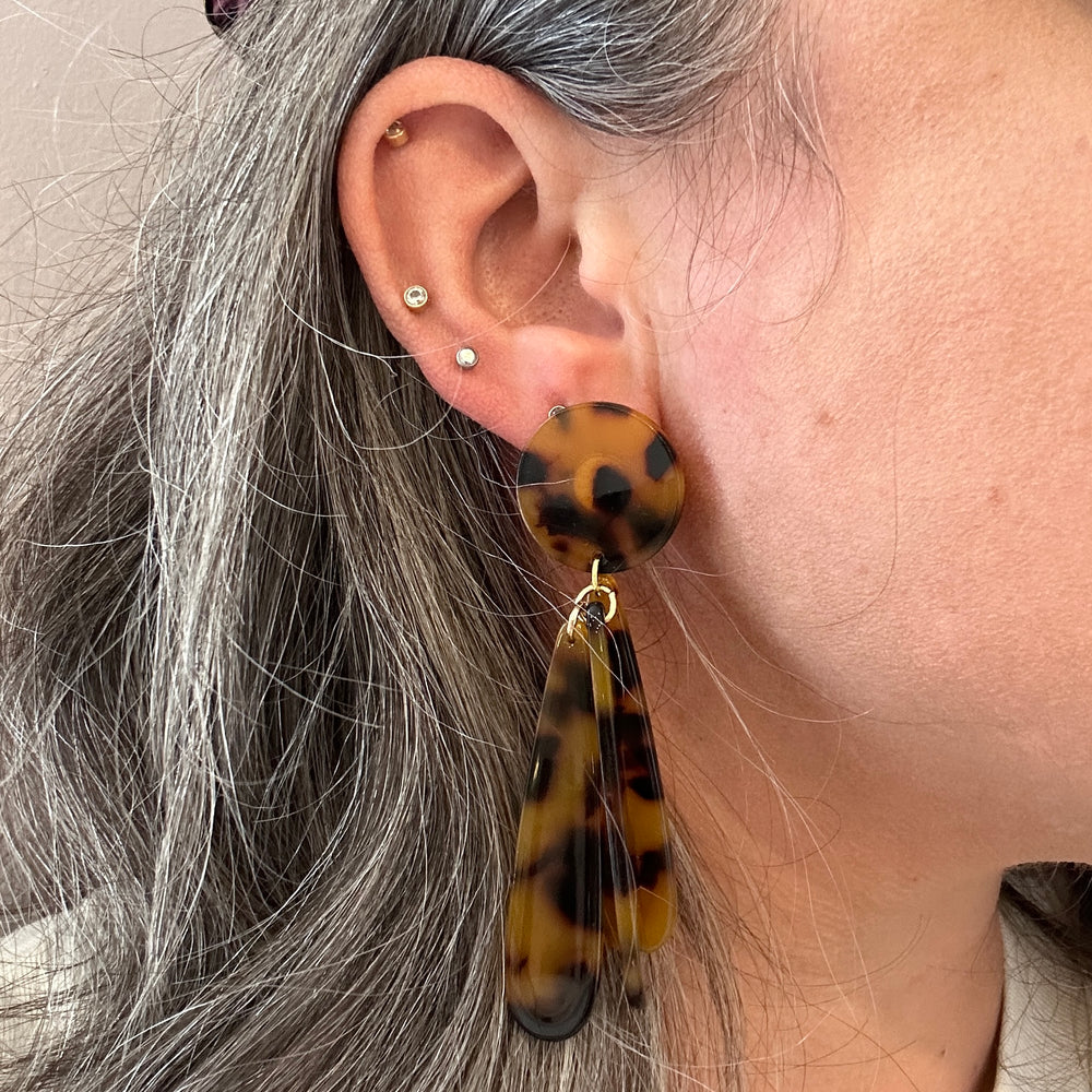 woman wearing acrylic flower Petal Drop Earrings in tortoise