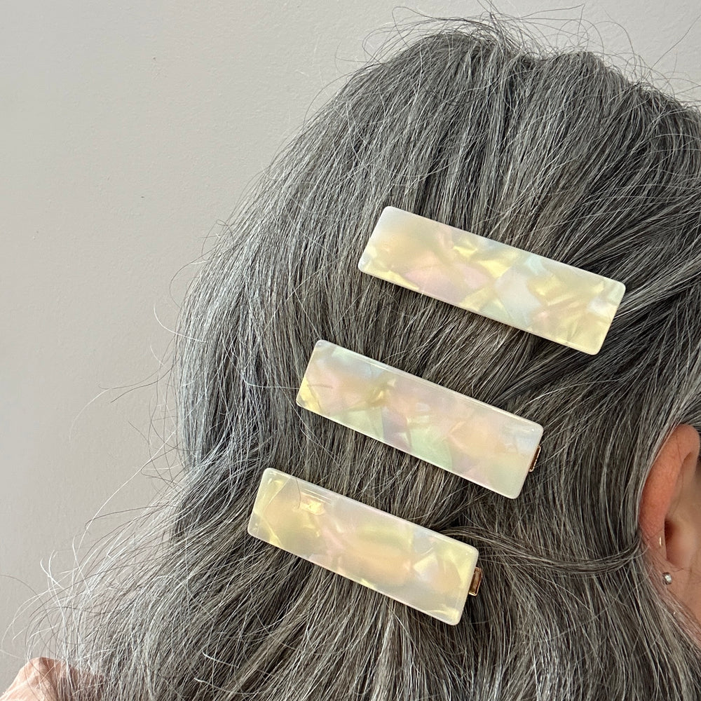 woman wearing acrylic hair clip set in opal