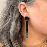 woman wearing acrylic matchstick earrings in black