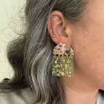 woman wearing close up of acrylic Fringe Earrings in green and pink