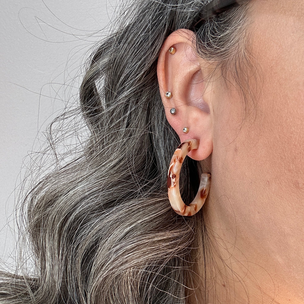 women wearing Acrylic Hoop Earrings in cream and brown