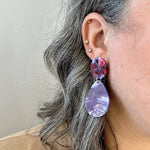 women wearing acrylic teardrop earrings in purple and red