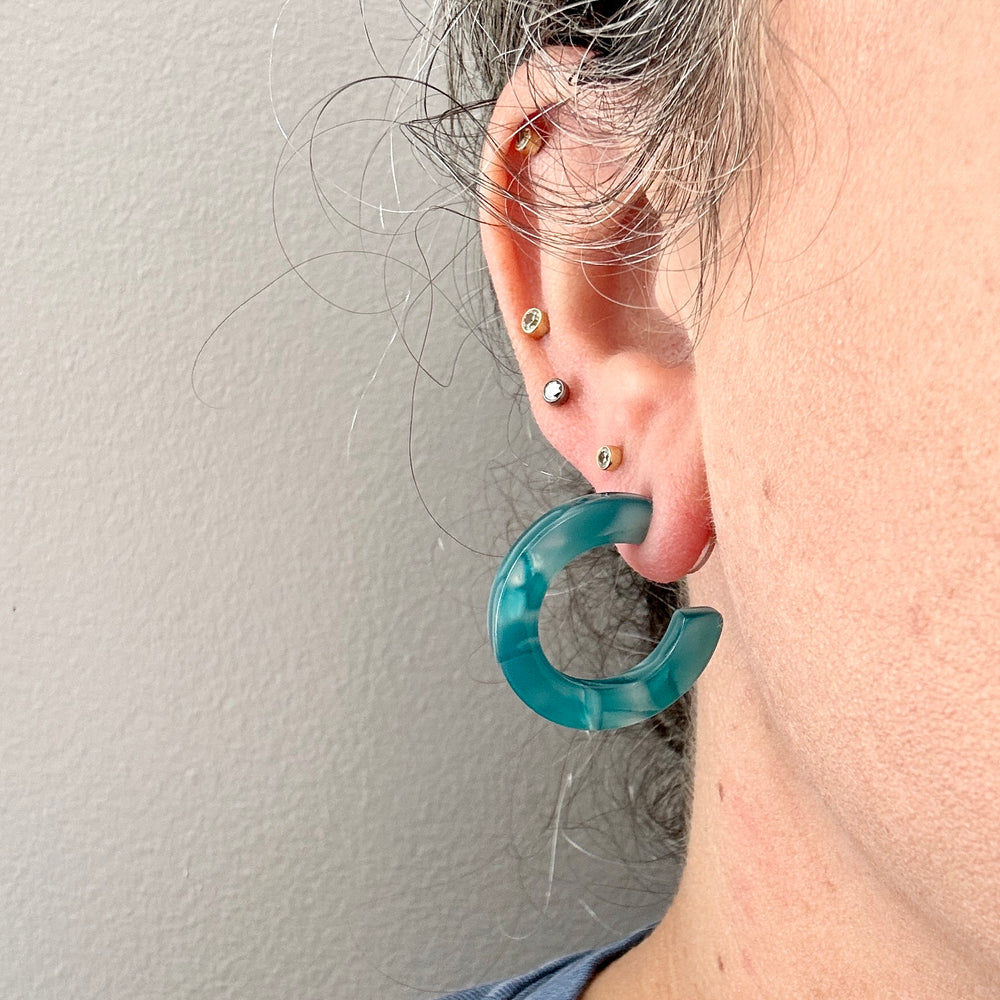 women wearing mini acrylic hoop earrings in blue 