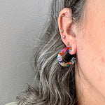 women wearing mini acrylic hoop earrings in multicolor