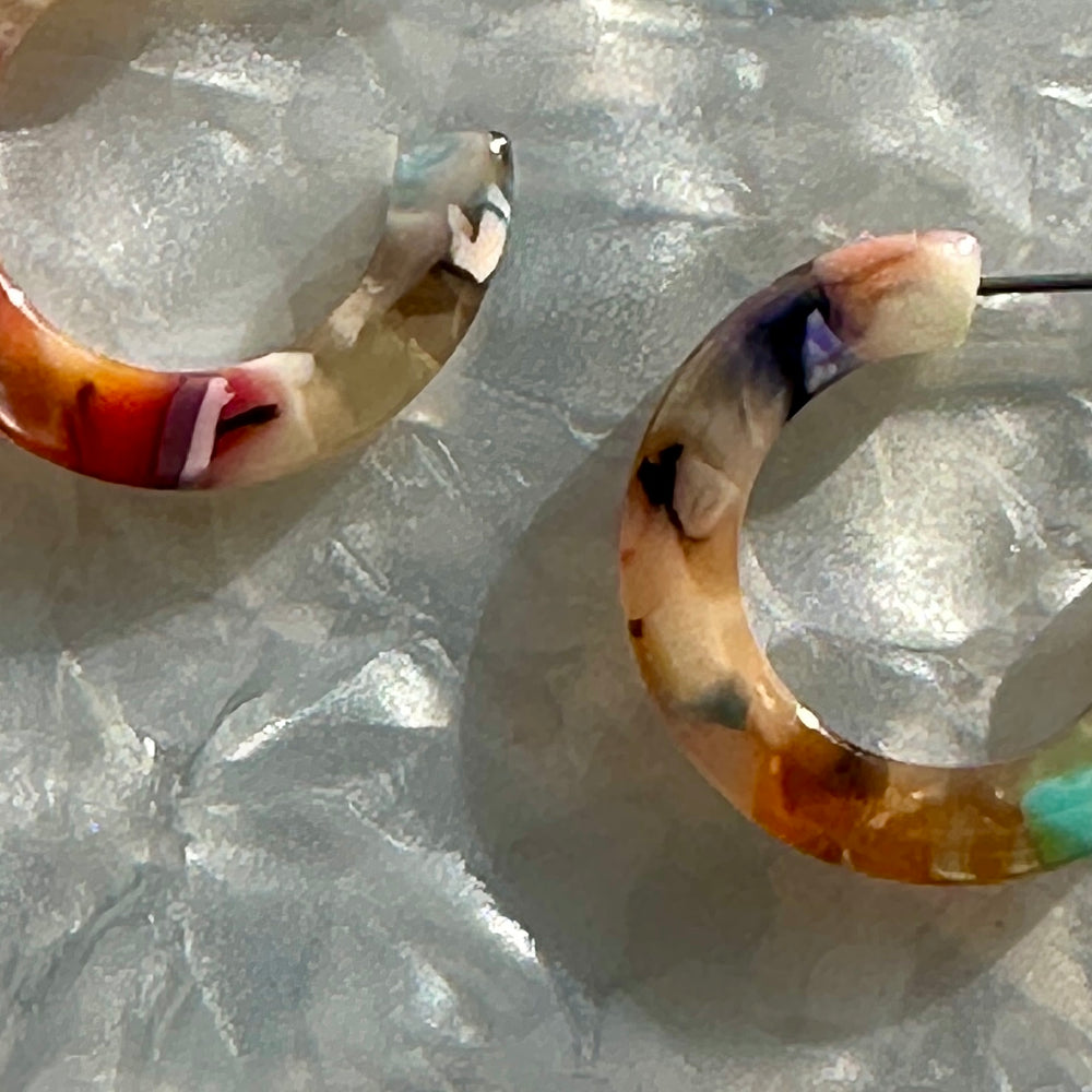 Person wearing Mini Acrylic Light Multicolored Hoop Earrings