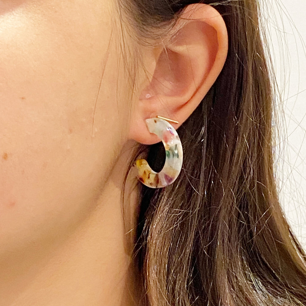 Person wearing Mini Acrylic Light Multicolored Hoop Earrings