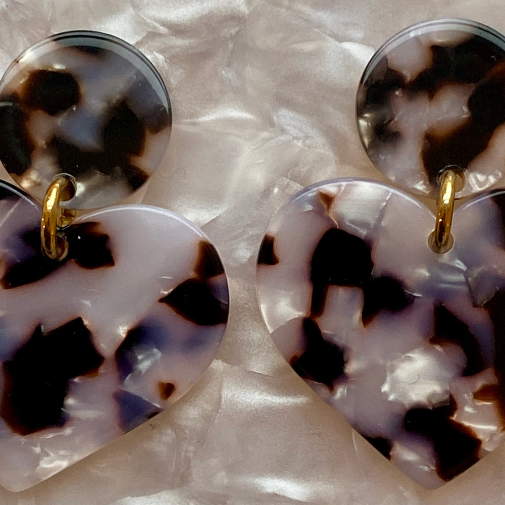 woman wearing acrylic Heart Earrings in Pearly Tortoise, black and white 