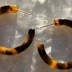 Woman wearing Acrylic Hoop Earrings in Tortoise