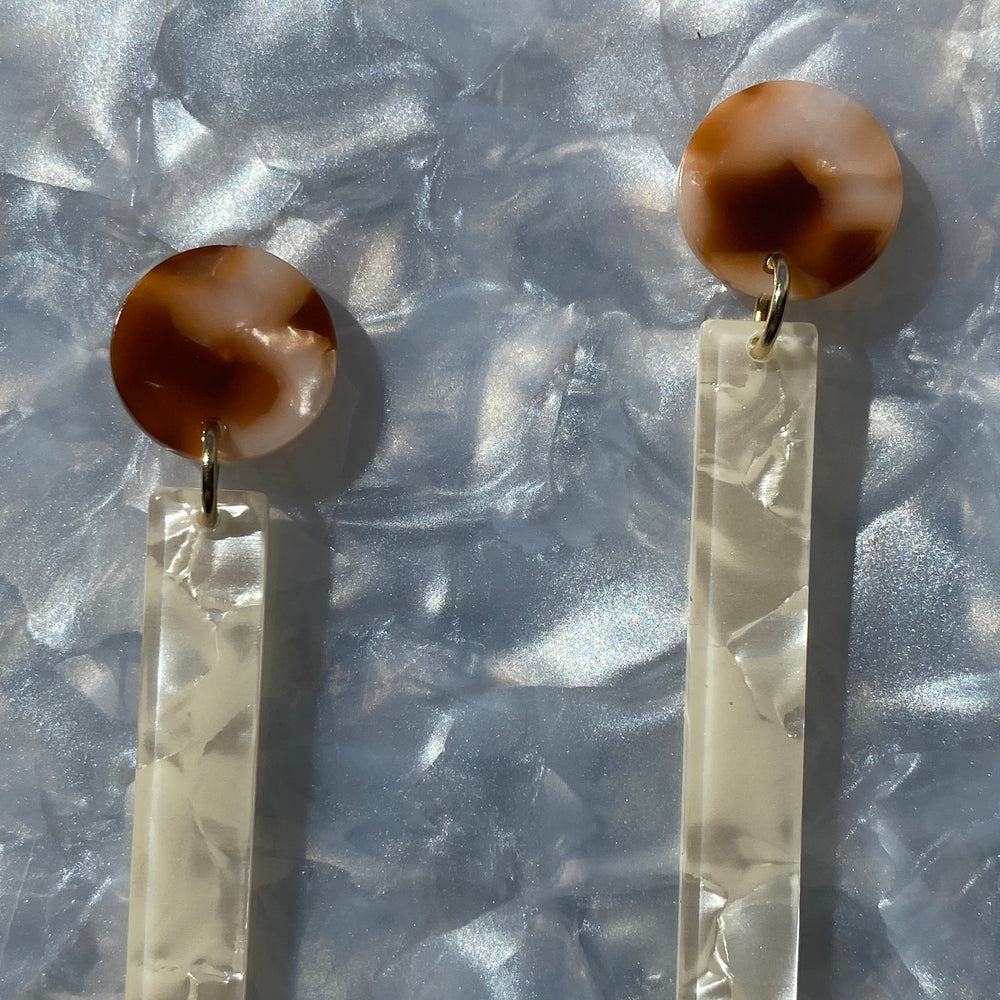 woman wearing acrylic Matchstick Drop Earrings in cream and brown