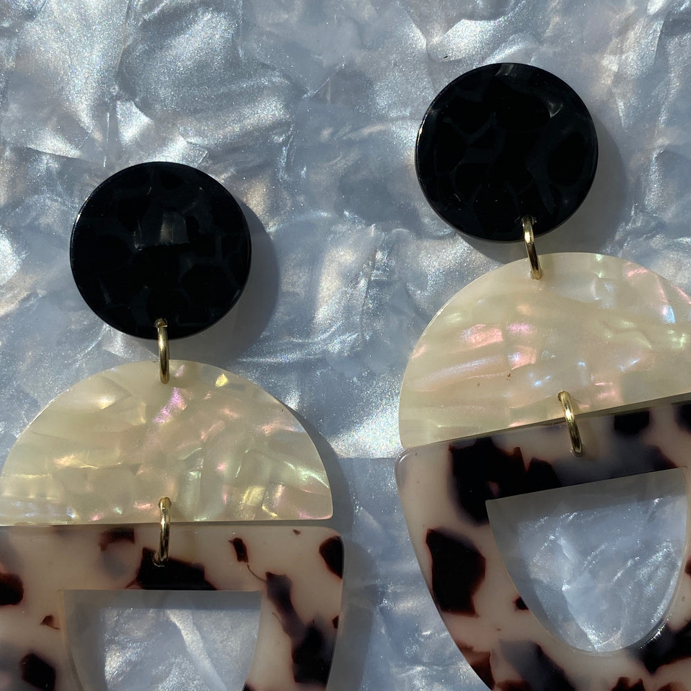 woman wearing acrylic Open Tab Drop Earrings in black, cream and tortoise