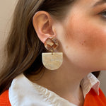 woman wearing acrylic Tab Drop Earrings in cream and brown